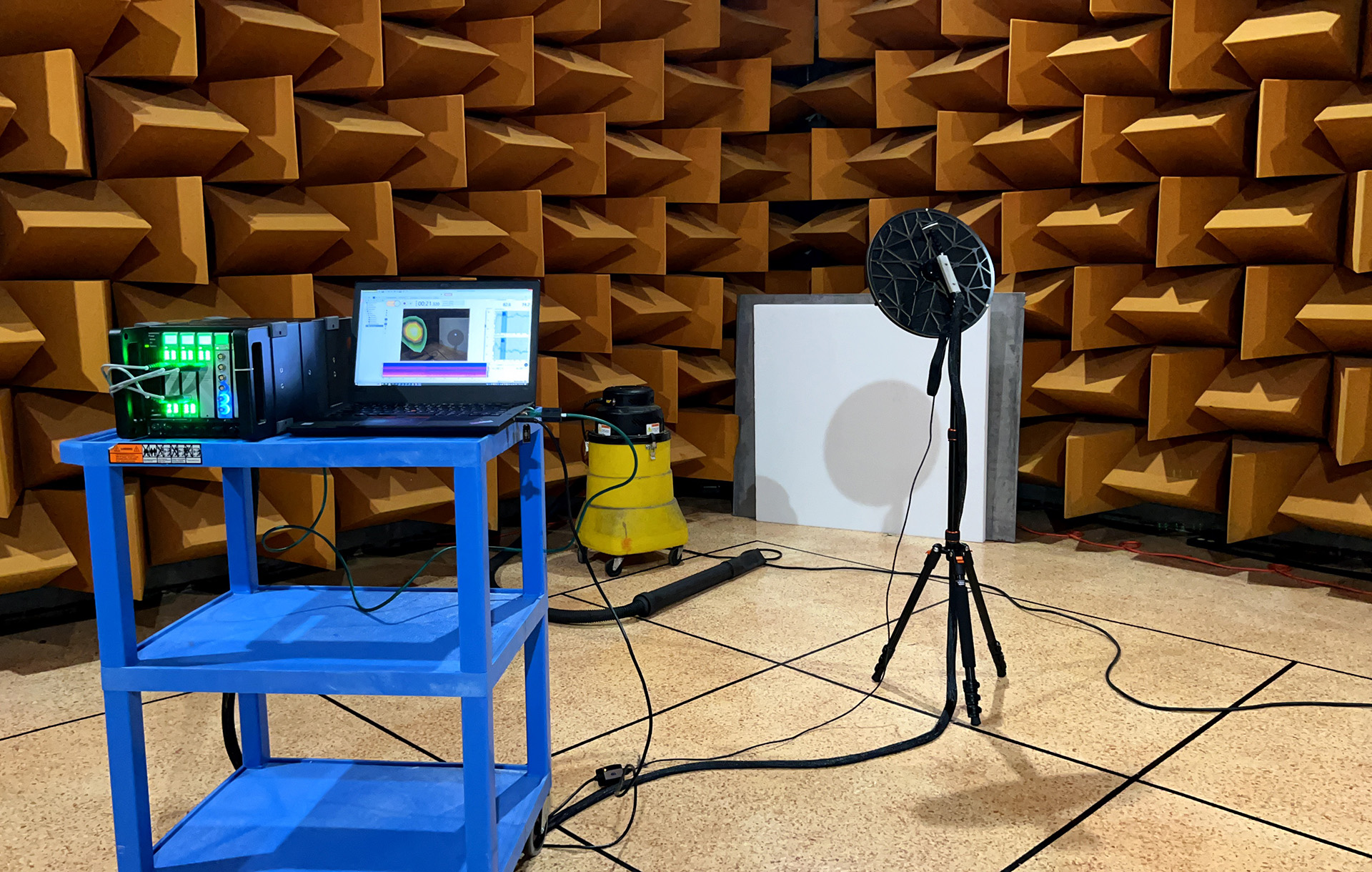 Inside a hemi-anechoic chamber with a sound camera in use in front of a motorized appliance