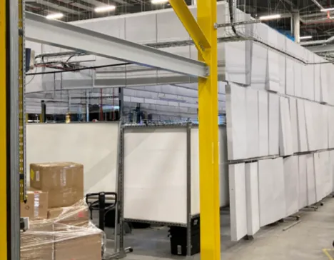 Foam panels hanging around a workstation in an attempt to quiet the factory noise.